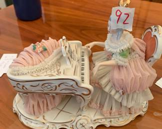 #92 dresden lace porlain lady with piana as is small chip $75.00