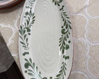 vintage oval serving platter featuring a hand-painted green botanical or leaf pattern on a cream-colored glazed surface
