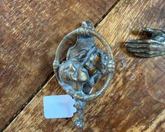 vintage brass door knocker featuring a romantic kissing couple 