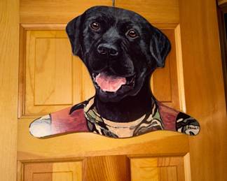 vintage collectible wooden clothes hanger featuring a hand-painted black Labrador Retriever, frequently associated with artist Annie Rhinehart. 