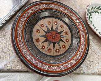 Burnished sun face pottery plate