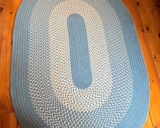 Blue and white braided oval rug, measures 47.5” x 6’