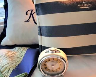 The pillow says "Kelly" in case you know one, and the Kate Spade purse is actually a powering station for your electronics!