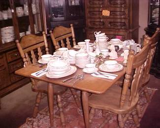 Side drop-leaf table, 4 matching chairs, beautiful china pattern.  Hall's Autumn Leaf in the china cabinet to the left in the picture.