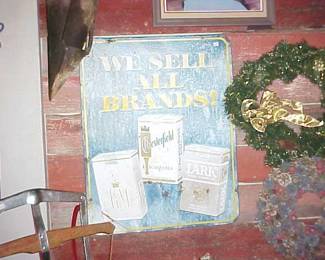 Large metal cigarette advertising sign.