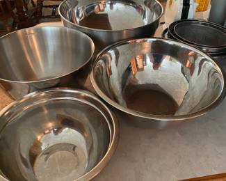 Many different shapes and sizes of metal bowls