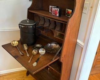 Another view of the primitive secretary’s desk - shown with silver-plated servers, and  bar ware