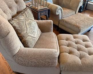 Two well lived club chairs with ottomans 