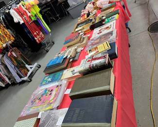 Lots of old books, recipe books, baby books by Spock, some videos, some sports equipment old tennis rackets old bat old aluminum pans old baskets some over 100 years old