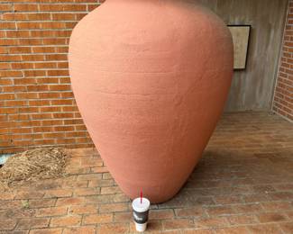 5' vase that is a 32oz cup in front 