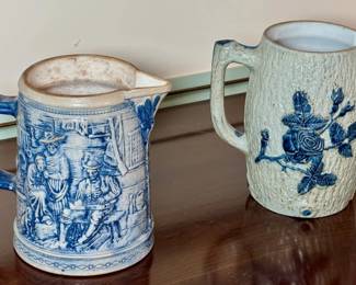 2 blue and white stoneware pitchers.
