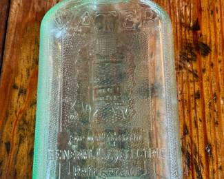 Vintage GE refrigerator green glass water bottle.