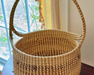 Sweet grass handled basket with knot design.