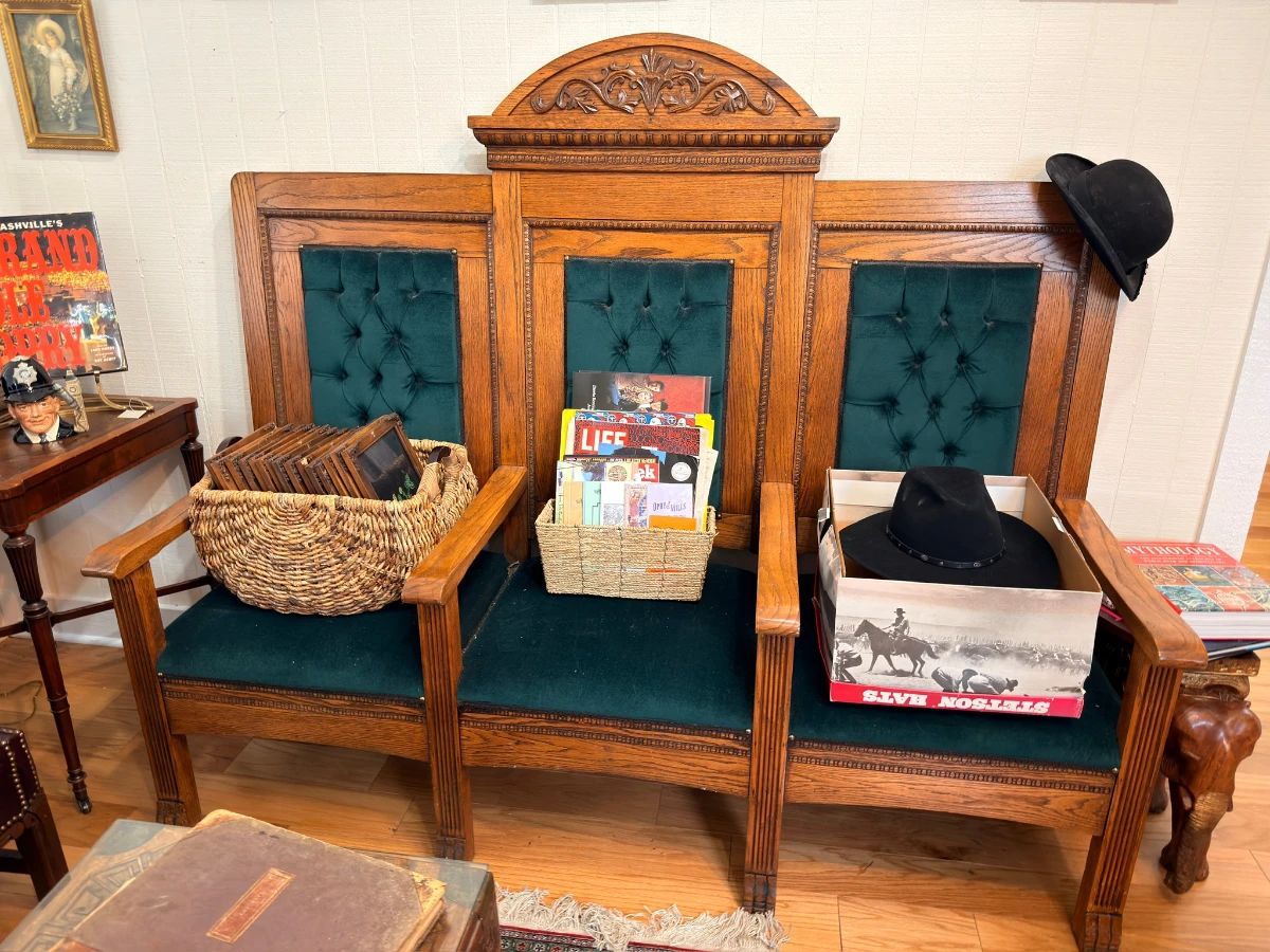 Antique oak three-seat church pew with tufted green velvet