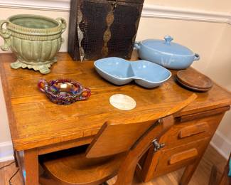 Antique oak drop-leaf table with pottery and vintage tackle box