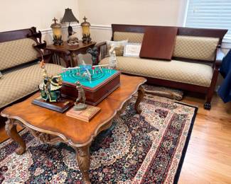 Carved wood coffee table, upholstered settee, Persian area rug