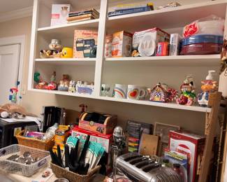 Kitchen pantry with small appliances, novelty teapots, and utensils