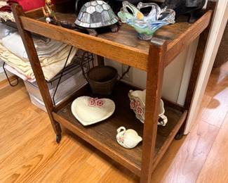 Vintage rolling oak tea cart with floral tray and serving pieces