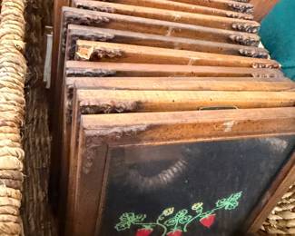 Collection of framed vintage pictures in basket