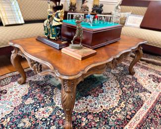 Ornate carved wood coffee table with cabriole legs