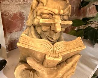 Whimsical garden statue of reading gnome