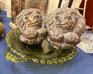 Pair lion figurines on green depression glass dish