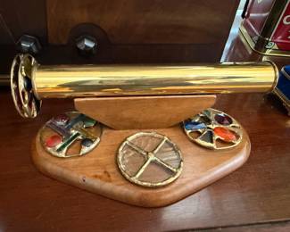 Brass kaleidoscope on wooden stand