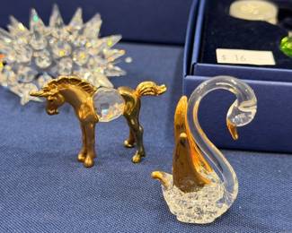Gold horse, crystal swan, and crystal porcupine figurines