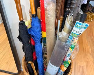 Umbrellas and wrapping paper in wicker basket