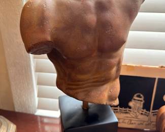 Classical male torso sculpture on pedestal