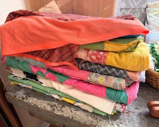 Stack of vintage handmade patchwork quilts