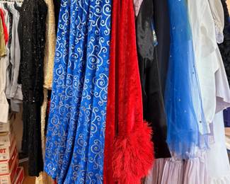 Theatrical costumes and sequined gowns on rack