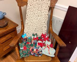 Antique oak cane-seat rocking chair with crochet throw