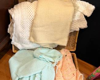 Basket of crocheted and knit baby blankets