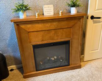 traditional electric fireplace with an oak wood mantel