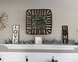 wall arrangement features a tobacco basket adorned with a lambs ear wreath, flanked by "LOVE" and "HOME" signs