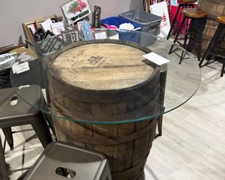 Rustic whiskey barrel bistro table topped with a circular glass surface