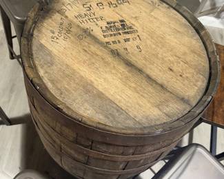 Rustic whiskey barrel bistro table topped with a circular glass surface