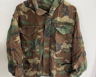 vintage US Army M-65 field jacket in a woodland camouflage pattern