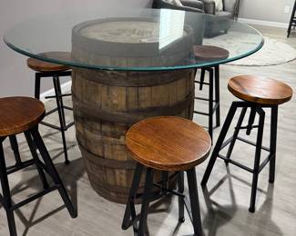 Rustic whiskey barrel bistro table topped with a circular glass surface
