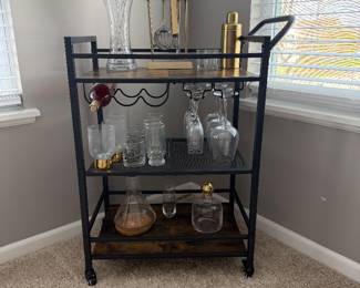  bar cart, a 3-tier mobile serving station featuring a metal frame, rustic wood shelves, a built-in wine bottle rack, and stemware storage. 