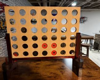 four-in-a-row board game made of finished wood designed for oversized play.