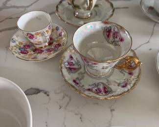 assortment of tea cups and saucers