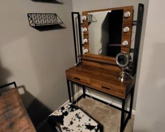 industrial-style makeup vanity desk featuring a rustic brown wood finish, black metal frame, and a lighted mirror