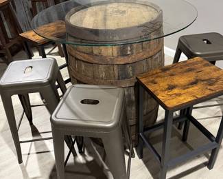 Rustic whiskey barrel bistro table topped with a circular glass surface