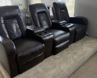 Home theater seating three (3) comfortable reclining seats with storage compartments and cup holders.