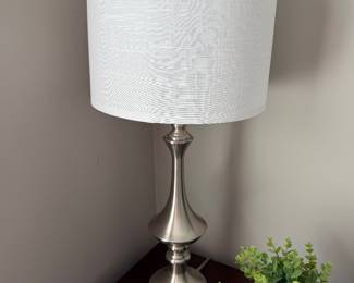  brushed steel finish table lamp with a white fabric drum shade