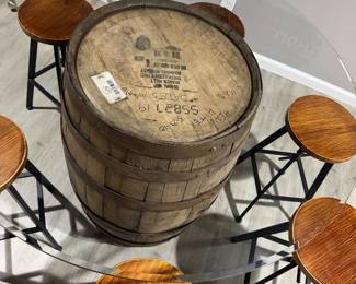 Rustic whiskey barrel bistro table topped with a circular glass surface