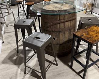 Rustic whiskey barrel bistro table topped with a circular glass surface