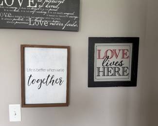 three wall signs focusing on themes of love and togetherness, including a passage from 1 Corinthians 13
